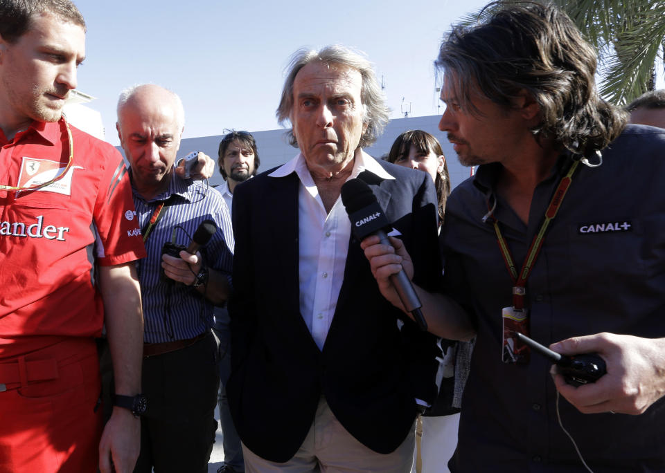 Ferrari president Luca di Montezemolo walks in the paddock surrounded by reporters, after a meeting with Bernie Ecclestone, president and CEO of Formula One Management, and Jean Todt FIA president, ahead the Bahrain Formula One Grand Prix at the Bahrain International Circuit in Sakhir, Bahrain, Sunday, April 6, 2014. Ecclestone said he expects to get agreement to change the sport's "unacceptable" engine rules, despite leading team Mercedes opposing any alteration. Ferrari and Red Bull have led the charge against the sport's new fuel limits that restrict usage to 100 kilograms per car per race, with the flow never exceeding more than 100 kilograms per hour. The muted sound of the new 1.6 liter V6 turbo hybrid engines has also attracted criticism. (AP Photo/Luca Bruno)