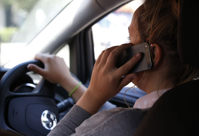 Embargoed to 0001 Thursday September 21 POSED BY MODEL File photo dated 13/08/14 of a woman using a mobile phone while driving. Millions of Britons may still be using their mobile phones while driving despite penalties for the offence being doubled, research suggests.