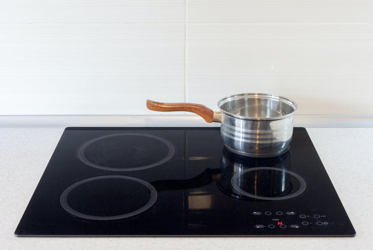 Bye-bye, burners. <a href="https://www.gettyimages.com/detail/photo/pot-in-modern-kitchen-with-induction-stove-royalty-free-image/501706822?adppopup=true" rel="nofollow noopener" target="_blank" data-ylk="slk:brizmaker/iStock/Getty Images Plus;elm:context_link;itc:0;sec:content-canvas" class="link ">brizmaker/iStock/Getty Images Plus</a>