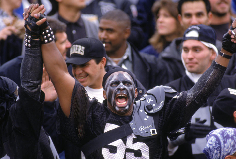 A Los Angeles Raiders fan cheers during the game against the Buffalo Bills at the Los Angeles Memorial Coliseum in Los Angeles, California, on December 8, 1991. The Bills won 30-27 in overtime. (George Rose/Getty Images)