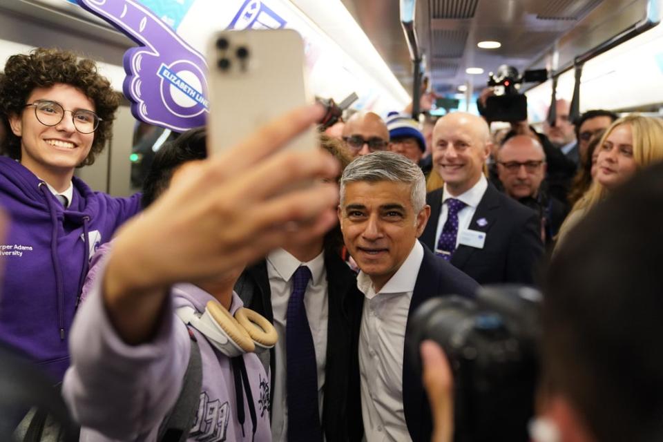 Mr Khan posed for a selfie on board the first Elizabeth line train to carry passengers at Paddington Station (Kirsty O’Connor/PA) (PA Wire)