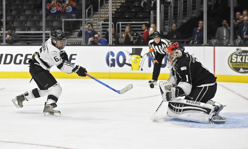 Singer Justin Bieber, left, of Team Gretzky, tries to get a shot past Team Lenieux goalie Jamie Storr during the first period of the NHL All-Star Celebrity Shootout at Staples Center, Saturday, Jan. 28, 2017, in Los Angeles. The NHL All-Star Game is scheduled to be played at Staples Center on Sunday. (AP Photo/Mark J. Terrill)