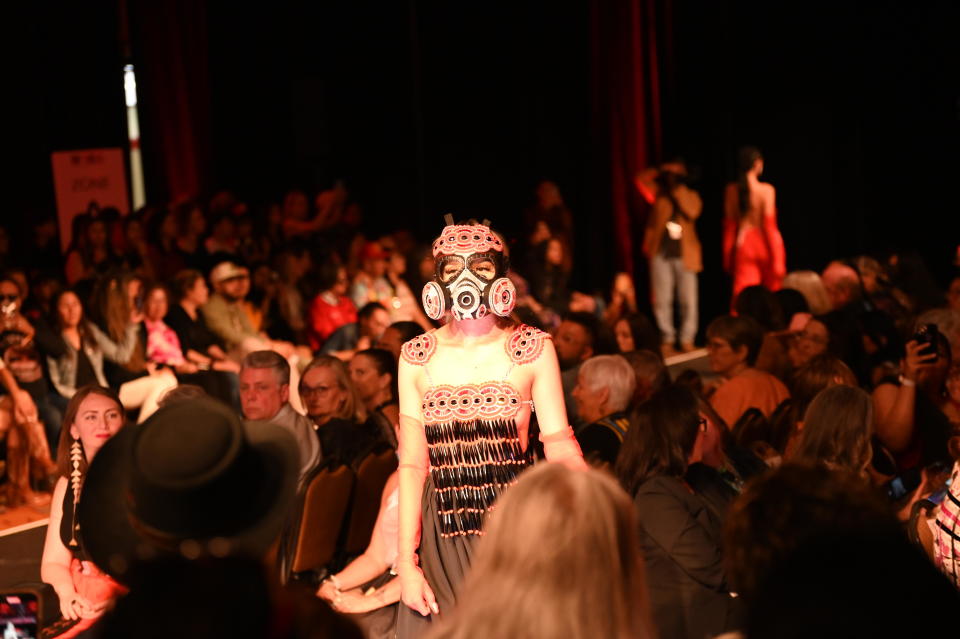 A model walks the runway in an original design by an Indigenous creator at Native Fashion Week in Santa Fe. Indigenous designers gathered for the inaugural Native Fashion Week staring May 5 in a celebration of Native creations and culture. / Credit: Elly Mui / CBS News