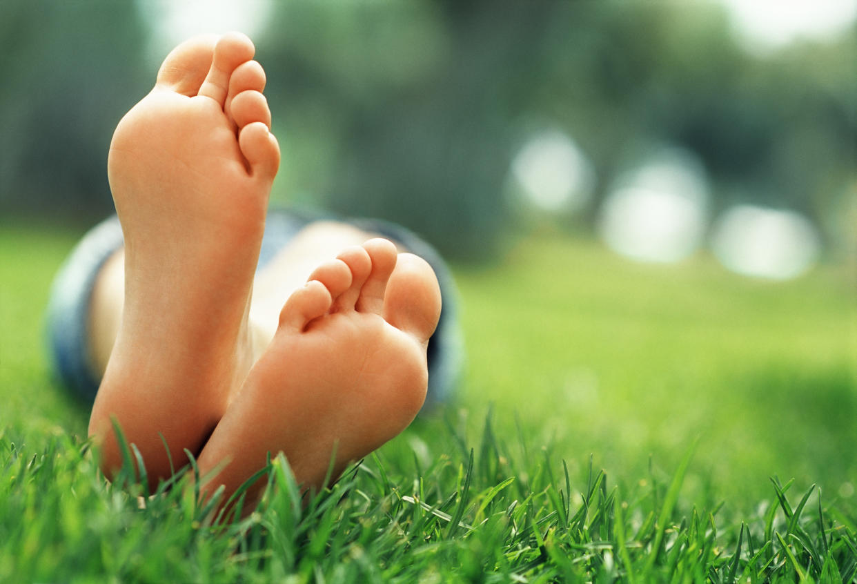 Person laying down with foot in grass