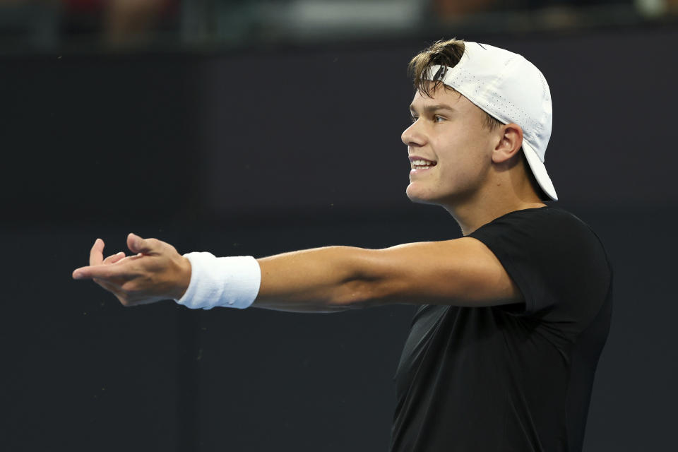 Holger Rune of Denmark reacts after missing a shot in his match against Max Purcell of Australia during the Brisbane International tennis tournament in Brisbane, Australia, Monday, Jan. 1, 2024. (AP Photo/Tertius Pickard)