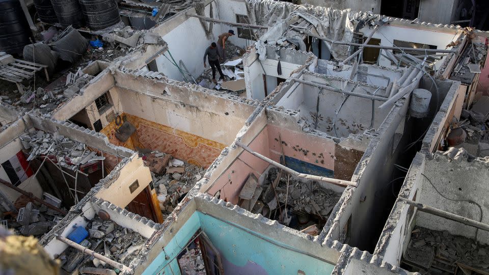 Palestinians inspect a house damaged in an Israeli strike in Rafah, in the southern Gaza Strip, on Tuesday. - Hatem Khaled/Reuters