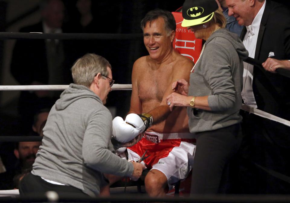 Mitt Romney is tended to in the corner of the ring by his wife Ann Romney and former Utah Governor Mike Leavitt as he fights five-time heavyweight champion Evander Holyfield during a boxing match in Salt Lake City, UT