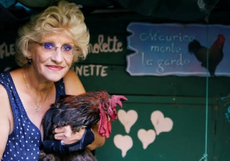 Corinne Fesseau poses with her rooster Maurice, whose loud crows landed him in court accused of noise pollution, in Saint-Pierre-d'Oleron