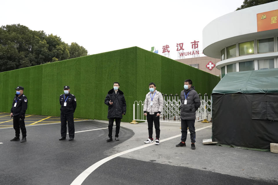 Security personnel guard an entrance to the Wuhan Jinyintan Hospital where a team from the World Health Organization visited in Wuhan in central China's Hubei province on Saturday, Jan. 30, 2021. (AP Photo/Ng Han Guan)