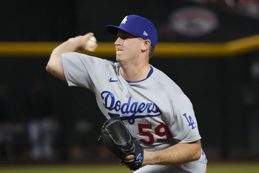 Dodgers relief pitcher Evan Phillips throws to an Arizona Diamondbacks batter in the ninth innning