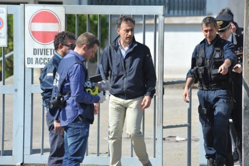 Police search the site of a blast near a school in Brindisi, Italy May 19. Police have arrested two suspects over the bombing that killed a 16-year-old girl and seriously injured five more teenagers