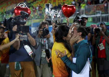Rugby player Isadora Cerullo of Brazil hugs her fiancee Marjorie, who works as a volunteer at the Olympics, after accepting her marriage proposal on the sidelines of the women's rugby medal ceremony. REUTERS/Alessandro Bianchi
