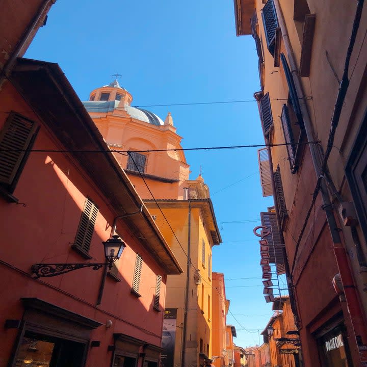 City streets in bologna with orange and pink buildings