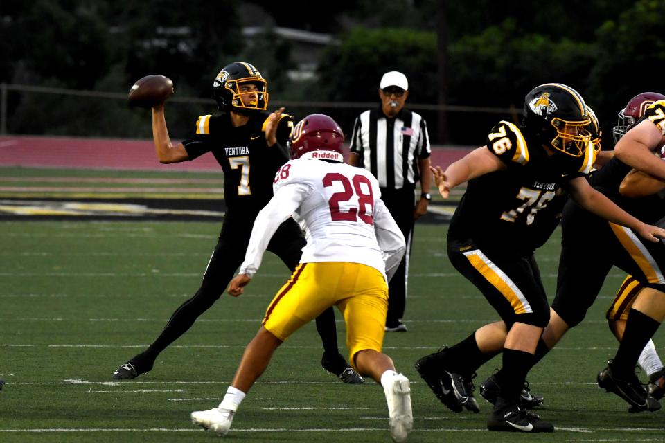 Ventura quarterback Logan Scarlett is ready to throw a pass before Oxnard's Gus Luna can get to him during the Cougars' 35-0 win in a nonleague game at Ventura High on Friday, Sept. 1, 2023. The game marked the 100th anniversary of the programs' first meeting.