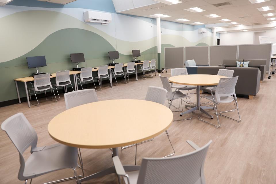 A common space in the navigation center has tables and computers for residents to use in April 2023 in Salem.