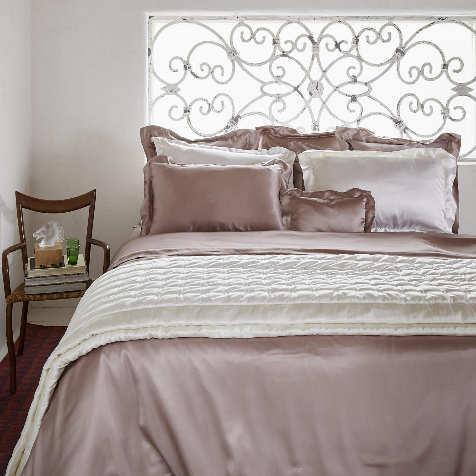 pink silk sheets in bedroom with white walls