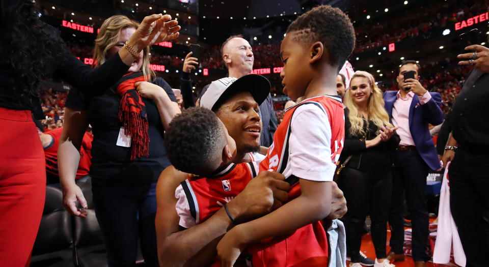 Toronto's Kyle Lowry celebrates with his sons Kameron and Karter after defeating the Milwaukee Bucks 100-94 in Game 6 of the NBA Eastern Conference Finals. (Photo by Gregory Shamus/Getty Images)