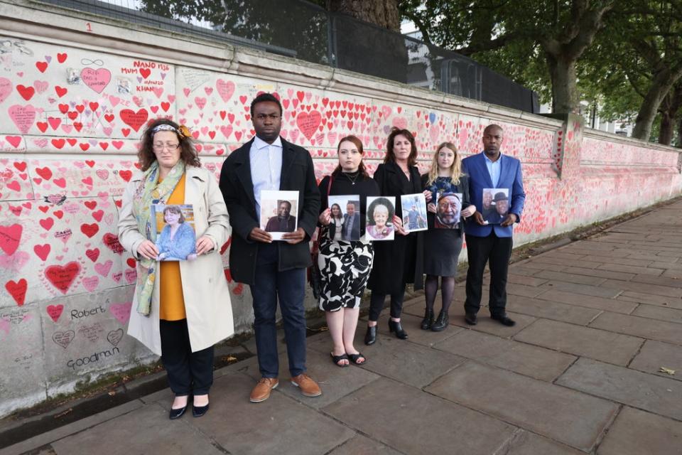 Bereaved people at the memorial wall (James Manning/PA) (PA Wire)