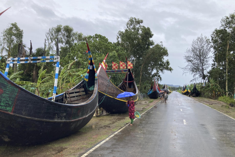 Boats are parked along a road near the coast in Cox's Bazar district, Bangladesh, Sunday, May 14, 2023. Bangladesh and Myanmar are bracing as an extremely severe cyclone starts to hit their coastal areas, and authorities urged thousands of people in both countries to seek shelter. (AP Photo/Al-emrun Garjon)