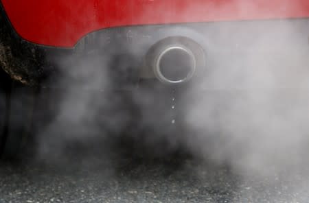 FILE PHOTO: An exhaust emits fumes as a car is driven through Richmond in London