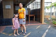 Judith Ramirez poses with her daughter Mary Ashley outside their home in Honolulu