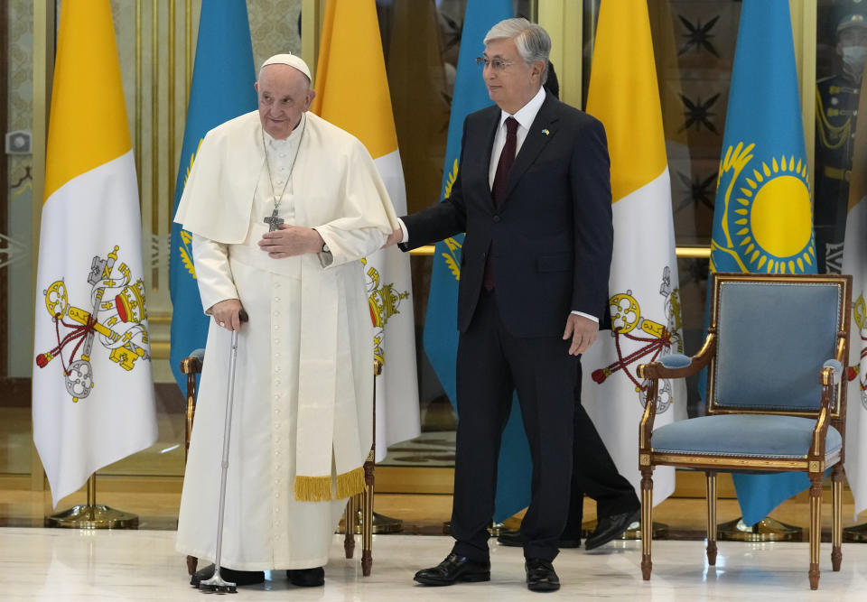 Pope Francis, left, meets the Kazakhstan's President Kassym-Jomart Tokayev as he arrives at Our-Sultan's International airport in Nur-Sultan, Kazakhstan, Tuesday, Sept. 13, 2022. Pope Francis begins a 3-days visit to the majority-Muslim former Soviet republic to minister to its tiny Catholic community and participate in a Kazakh-sponsored conference of world religious leaders. (AP Photo/Andrew Medichini)