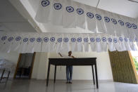 FILE- A man works on an under-production Indian national flag to dry in an office ahead of Independence Day in Gauhati, in the northeastern state of Assam, Aug. 2, 2022. India marks 75 years of independence from British rule on Aug. 15. (AP Photo/Anupam Nath, File)