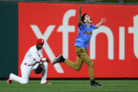 A young fan runs onto the field in front of left fielder Andrew McCutchen #22 of the Philadelphia Phillies during the third inning of a game against the New York Mets at Citizens Bank Park on April 16, 2019 in Philadelphia, Pennsylvania. The Phillies defeated the Mets 14-3. (Photo by Rich Schultz/Getty Images)