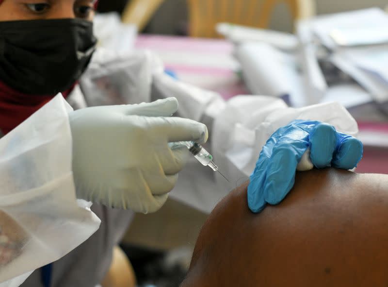 A man receives a dose of a vaccine against the coronavirus disease (COVID-19) at St. Paul's Church in Abu Dhabi