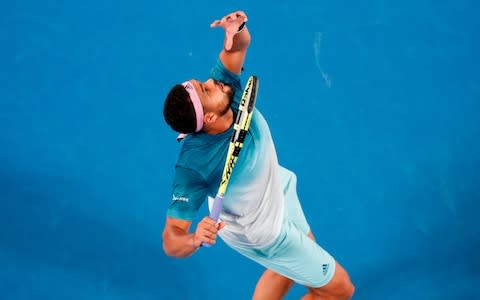 France's Jo-Wilfried Tsonga serves against Serbia's Novak Djokovic during their men's singles match on day four of the Australian Open tennis tournament in Melbourne on January 17, 2019 - Credit: AFP