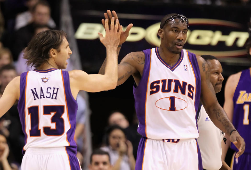 Amar'e Stoudemire and Steve Nash high-five during an NBA game.