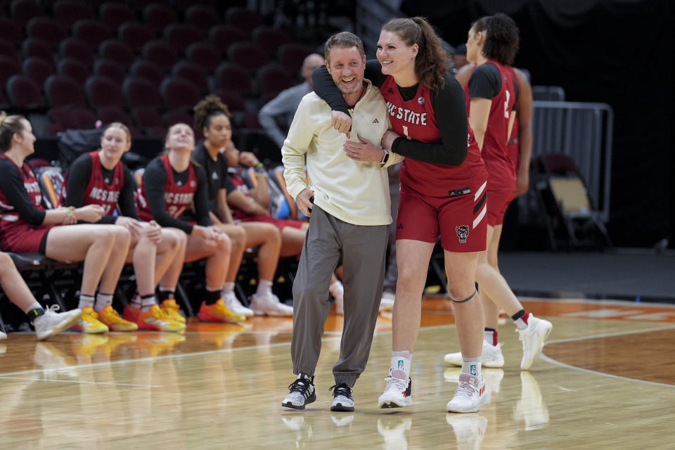 North Carolina State's River Baldwin hugs assistant coach Houston Fancer during a practice for an NCAA Women's Final Four semifinals basketball game Thursday, April 4, 2024, in Cleveland. (AP Photo/Morry Gash)