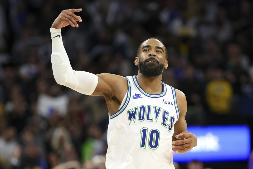 Minnesota Timberwolves guard Mike Conley gestures to the crowd after making a 3-point basket against the Los Angeles Lakers during the second half of an NBA basketball game Saturday, Dec. 30, 2023, in Minneapolis. (AP Photo/Matt Krohn)