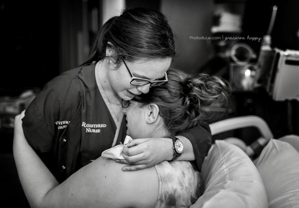 "This image shows a nurse comforting a mother after the sudden loss of her baby. It&rsquo;s a sad story but sheds light on a very caring nurse, who is shown here gifting this mom with a silver heart charm (in her hand)."