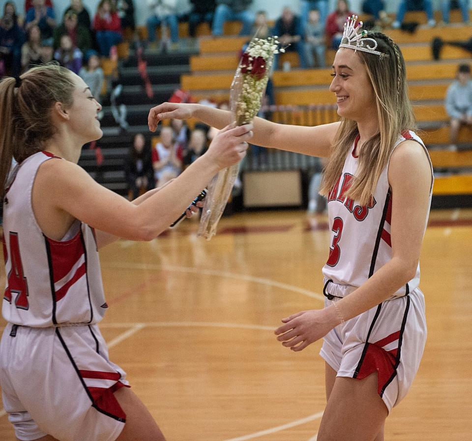 Hudson High School junior Samantha Collette, left,  honors Madison Kiley on Senior Night, Feb. 10, 2023.