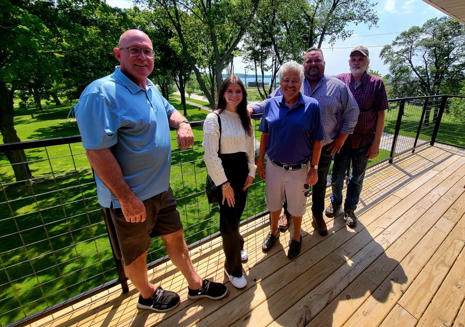 St. Clair County Board Chairman Jeff Bohm, from left, Sharon Torello, who's manning booking and operations at the Inn at Marysville Park, City Manager Randy Fernandez, developer Korety Eagen, and builder Dan Jackson stand on the inn's penthouse balcony on Wednesday, May 22, 2024.