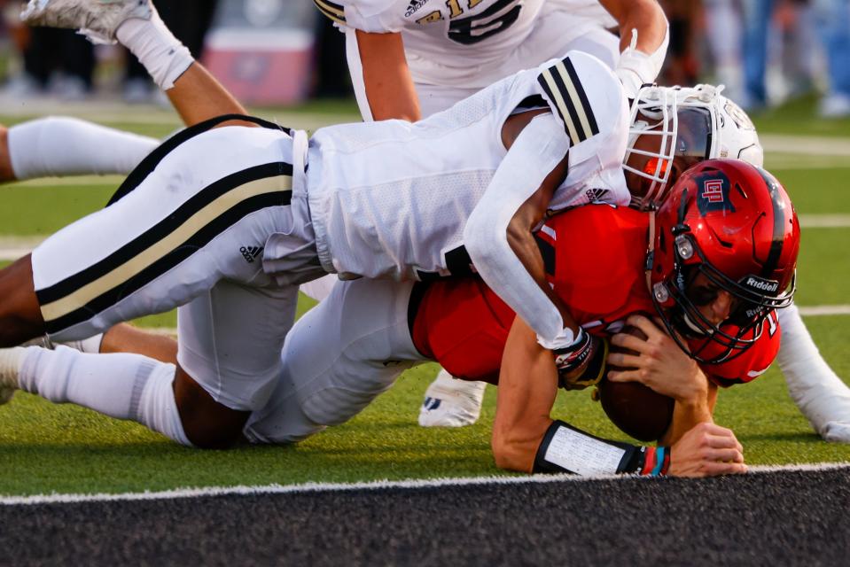 Lubbock-Cooper’s Tyler Spruiell (12) dives for the end zone against Wichita Falls Rider in a football game, Friday, Sept. 16, 2022, at Pirate Stadium at First United Park in Woodrow.