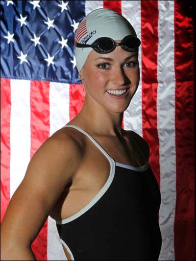 Lauren Perdue poses in front of the American flag.