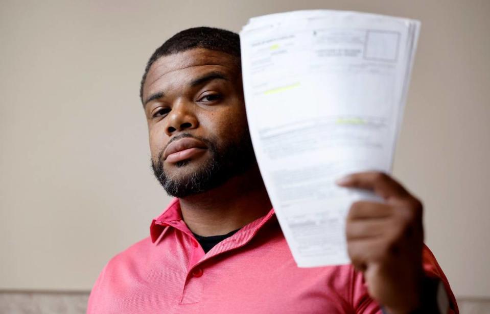 Outside a Wake County courtroom Aug. 24, Kevin Spruill holds up release paperwork he keeps with him in case he is stopped and detained by authorities on an arrest warrant that should have been recalled. Spruill is one of several plaintiffs who signed onto a potential class action lawsuit filed in federal courts alleging that the rollout of the state’s eCourt system violated their civil rights.