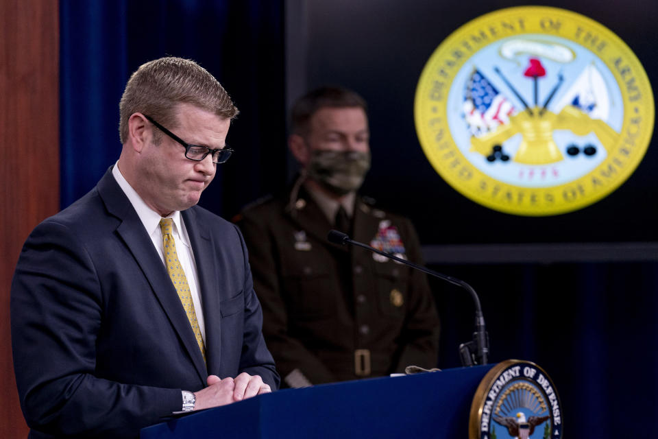 Secretary of the Army Ryan McCarthy, left, accompanied by Gen. James McConville, Chief of Staff of the Army, right, pauses while speaking about an investigation into Fort Hood, Texas at the Pentagon, Tuesday, Dec. 8, 2020, in Washington. The Army says it has fired or suspended 14 officers and enlisted soldiers at Fort Hood, Texas, and ordered policy changes to address chronic leadership failures at the base that contributed to a widespread pattern of violence including murder, sexual assaults and harassment. (AP Photo/Andrew Harnik)