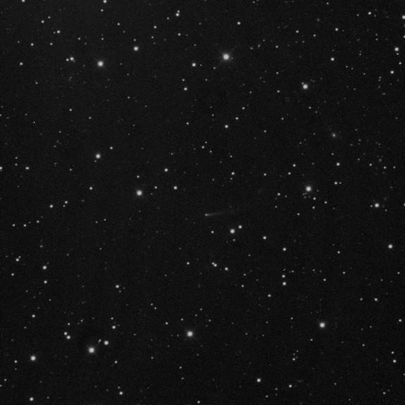 Comet 209P/LINEAR appears as a dim, dusty object at the center of this photo taken by NASA astronauts at the Marshall Space Flight Center in Huntsville, Ala. in May 2014. Dust from the comet is expected to create a meteor shower that will be fi