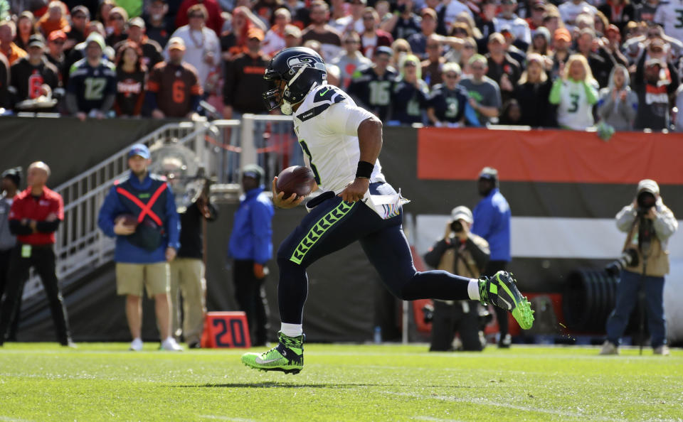 Seattle Seahawks quarterback Russell Wilson rushes for a 16-yard touchdown during the first half of an NFL football game against the Cleveland Browns, Sunday, Oct. 13, 2019, in Cleveland. (AP Photo/Ron Schwane)