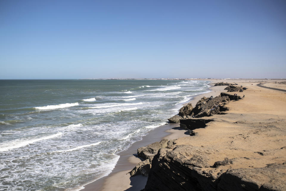 A view of the beach of the fishing town of La Sarga near Dakhla in Morocco-administered Western Sahara, Tuesday, Dec. 22, 2020. The peninsula city of Dakhla boasts a thriving fishing port, and kitesurfing enthusiasts flock to its waters. But in recent months, its beaches have become a hot spot of the moment for smuggling networks eyeing the Canaries, 500 kilometers (300 miles) north. (AP Photo/Mosa'ab Elshamy)