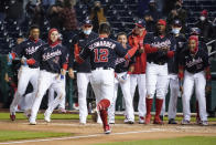 Washington Nationals' Kyle Schwarber (12) comes home to celebrate his game-winning home run during the ninth inning of a baseball game against the Arizona Diamondbacks at Nationals Park, Friday, April 16, 2021, in Washington. The Nationals won 1-0. (AP Photo/Alex Brandon)