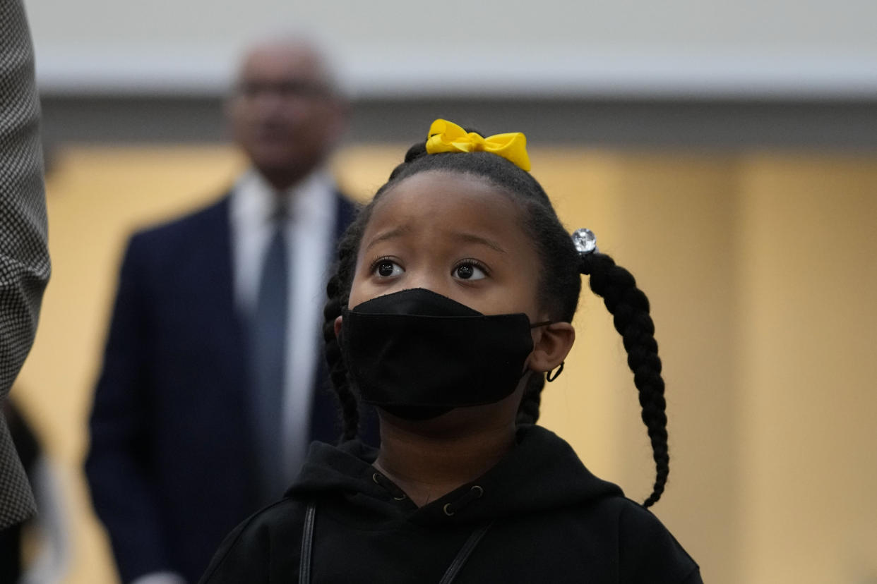 A child listens as people worship during Sunday services at the Mount Olive Cathedral CME Church, as the death of Tyre Nichols, who died after being beaten by Memphis police officers, was brought up during services, in Memphis, Tenn., Sunday, Jan. 29, 2023. (AP Photo/Gerald Herbert)