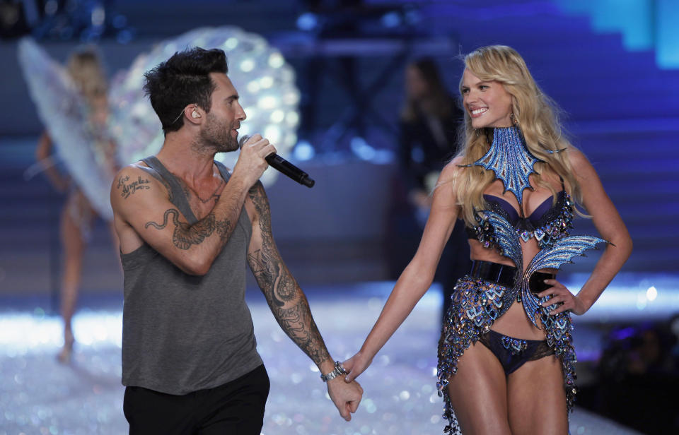 Levine, lead singer of Maroon 5, walks down the runway with model Vyalitsyna during the Victoria's Secret Fashion Show in New York