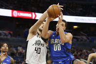 Orlando Magic forward Aaron Gordon (00) and Los Angeles Clippers center Ivica Zubac (40), from Croatia, battle for a rebound during the first quarter of an NBA basketball game in Orlando, Fla., Sunday, Jan. 26, 2020. (AP Photo/Reinhold Matay)