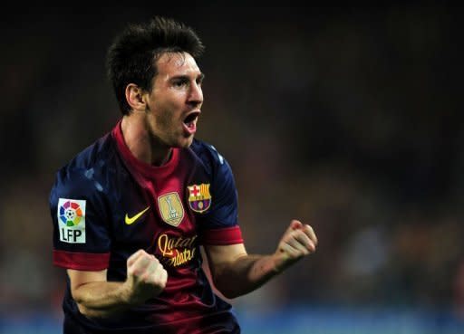 Barcelona's Argentinian forward Lionel Messi celebrates after scoring his second goal during the Spanish League Clasico football match FC Barcelona vs Real Madrid CF at the Camp Nou stadium in Barcelona. The match ended in a 2-2 draw