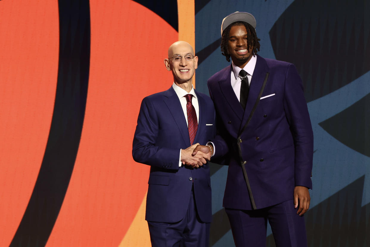 NEW YORK, NEW YORK - JUNE 26: DaRon Holmes II (R) shakes hands with NBA commissioner Adam Silver (L) after being drafted 22nd overall by the Phoenix Suns during the first round of the 2024 NBA Draft at Barclays Center on June 26, 2024 in the Brooklyn borough of New York City. NOTE TO USER: User expressly acknowledges and agrees that, by downloading and or using this photograph, User is consenting to the terms and conditions of the Getty Images License Agreement. (Photo by Sarah Stier/Getty Images)