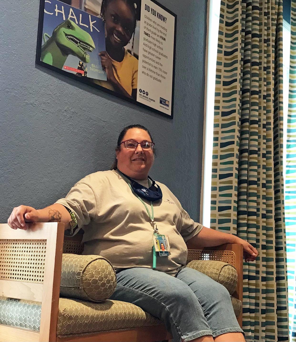 Lori Davis, 42, of South Venice, sits in the Newtown center where she works as a family advocate social worker. Long accustomed to helping others and referring some to Season of Sharing, she and her family recently hit hard times, and it was their turn to ask for assistance.